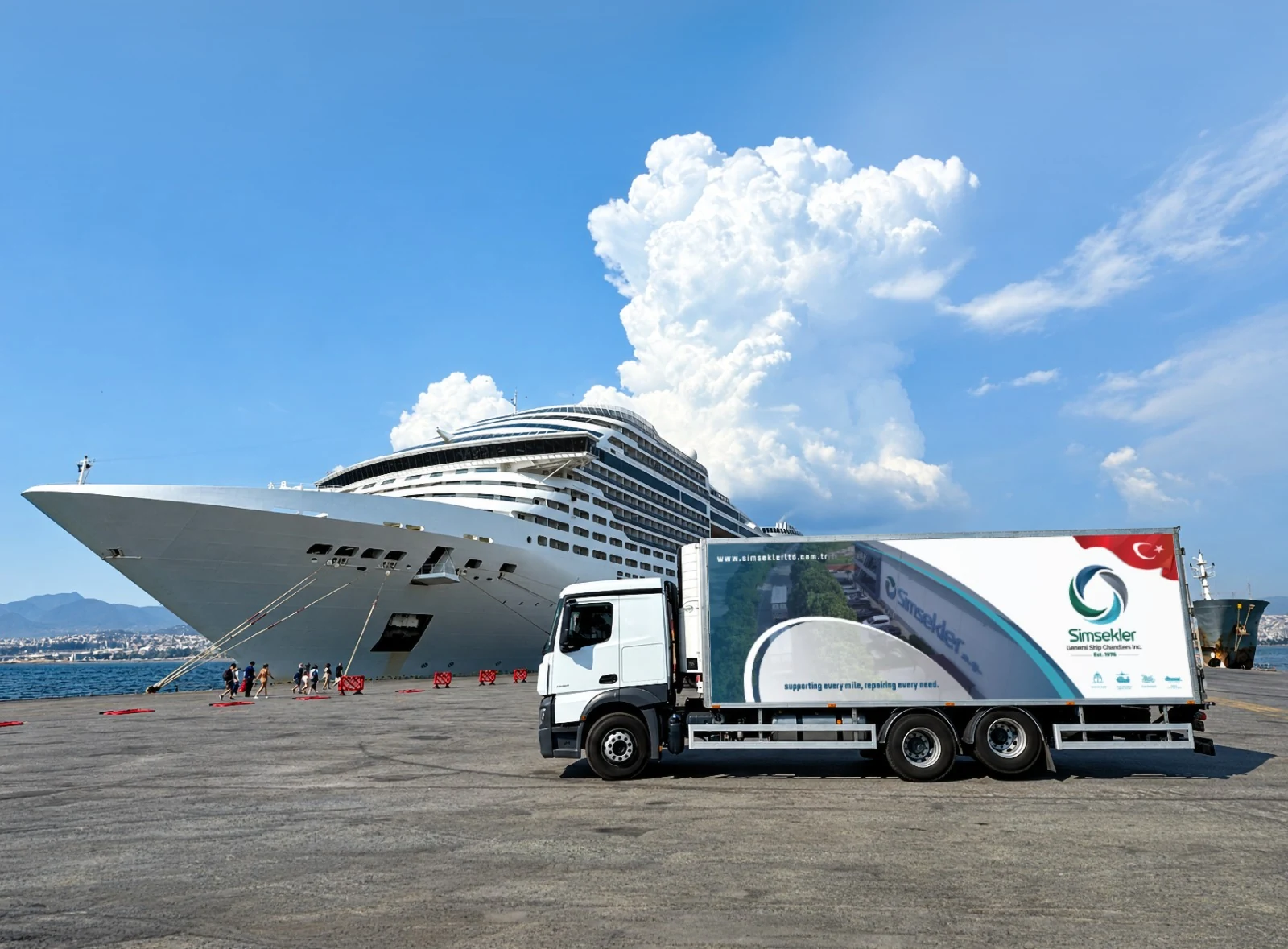 A Şimşekler supply truck beside a cruise ship at port