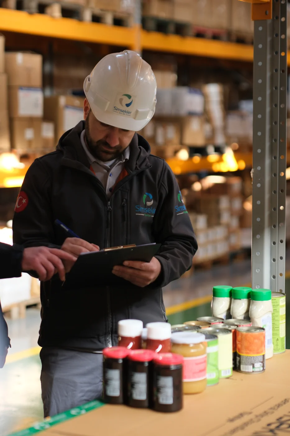 A Şimşekler team member checking provisions in the warehouse